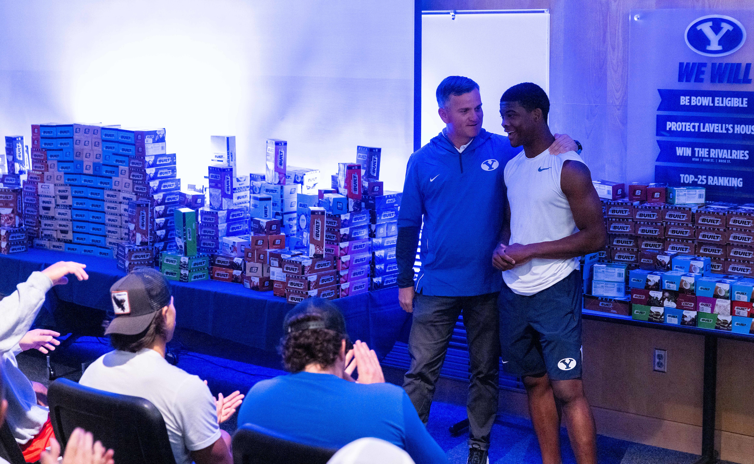 Built Bar co-founder Nick Greer surprises BYU walk-on quarterback and Utah transfer Nick Billoups as "employee No. 1" of a groundbreaking name, image and likeness agreement, Thursday, August 12, 2021 that will include compensation for every football player — including walk-ons.