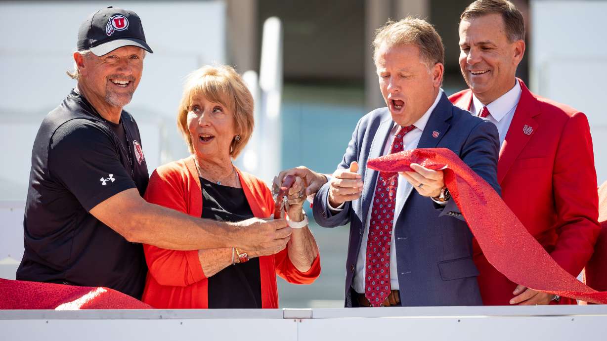 University of Utah football coach Kyle Whittingham, left, Katharine Garff, new U. President Taylor Randall and athletic director Mark Harlan cut the ribbon for the new Ken Garff Red Zone at Rice-Eccles Stadium in Salt Lake City on Thursday, Aug. 12, 2021.