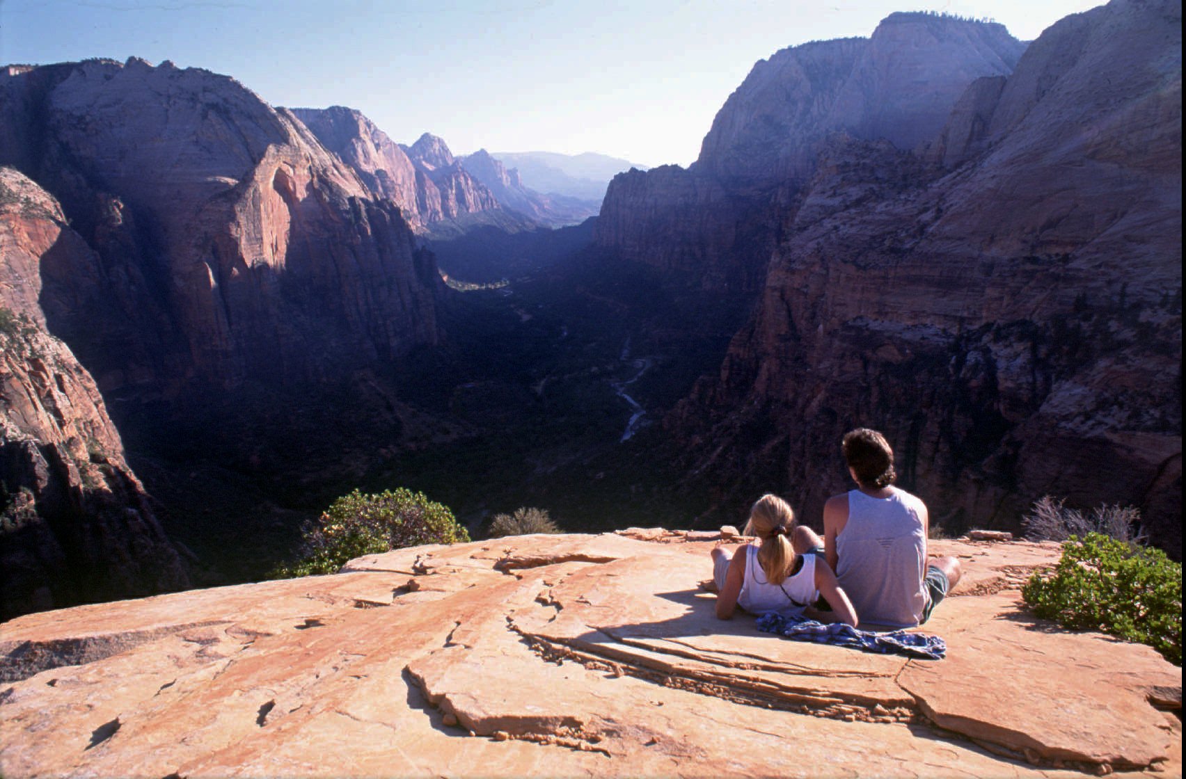 A couple enjoy the view of Zion National Park from Angel's Landing in this undated photo. Under a plan released Friday, park visitors would need a permit to reach this spot beginning in 2022.
