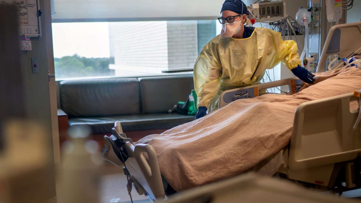 Pulmonology physician Catherine Wentowski, treats a patient who has COVID-19 at the Ochsner Medical Center in Jefferson Parish, Louisiana, on Tuesday. The U.S. Food and Drug Administration has authorized a third dose of COVID-19 vaccines by Pfizer and Moderna for people with compromised immune systems.