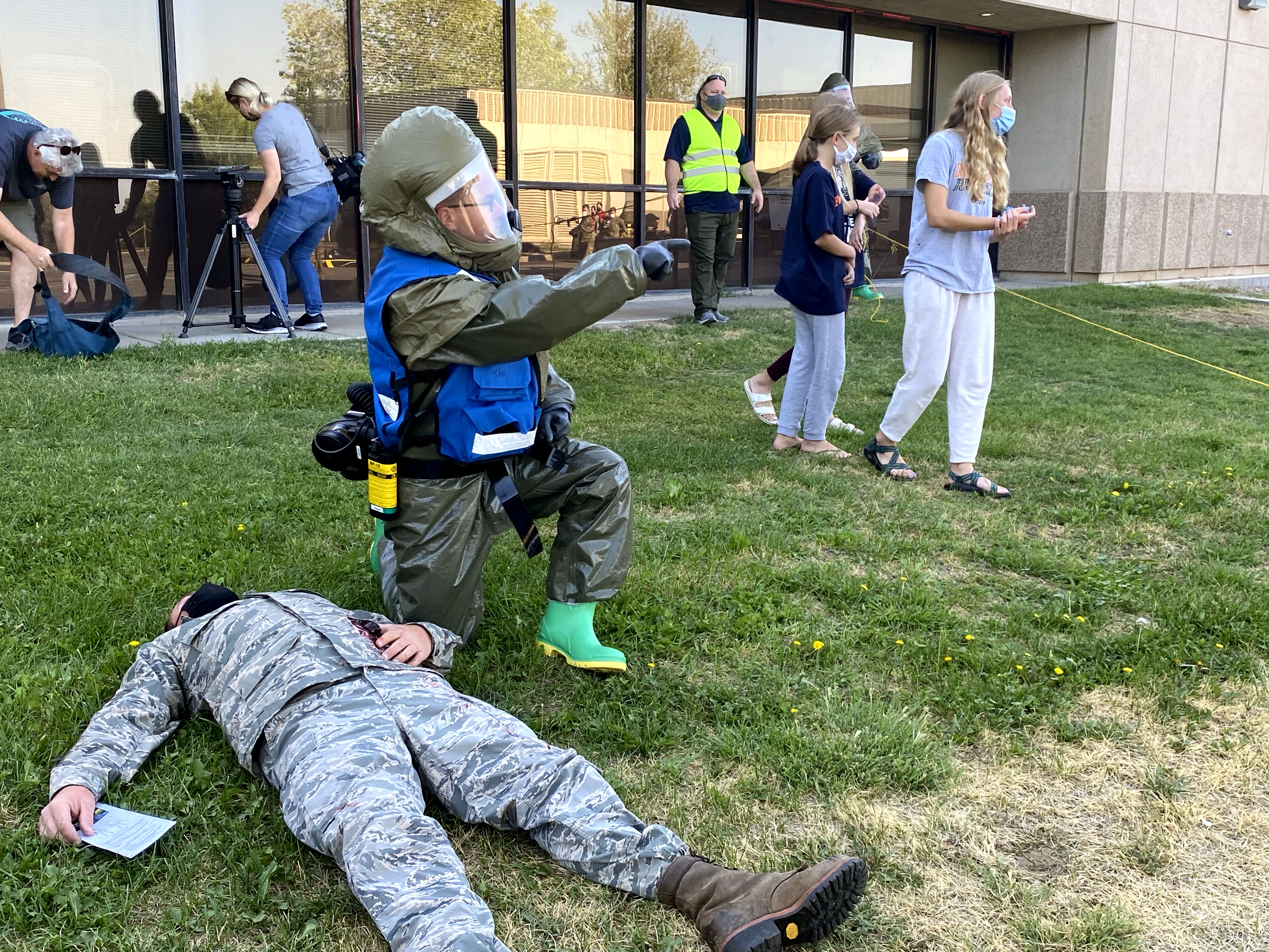 A medical airman equipped with a biohazard suit delivers medical treatment during a drill on Friday.