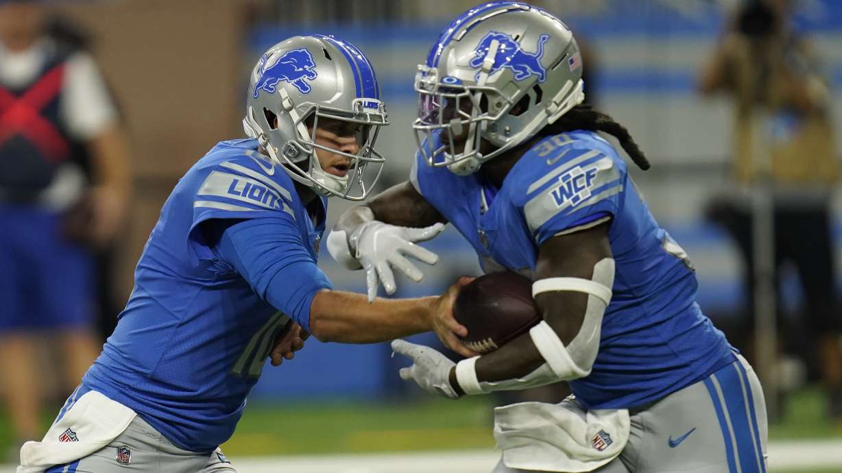 Detroit Lions quarterback Jared Goff, left, hands off to running back Jamaal Williams (30) during the first half of a preseason NFL football game against the Buffalo Bills, Friday, Aug. 13, 2021, in Detroit.