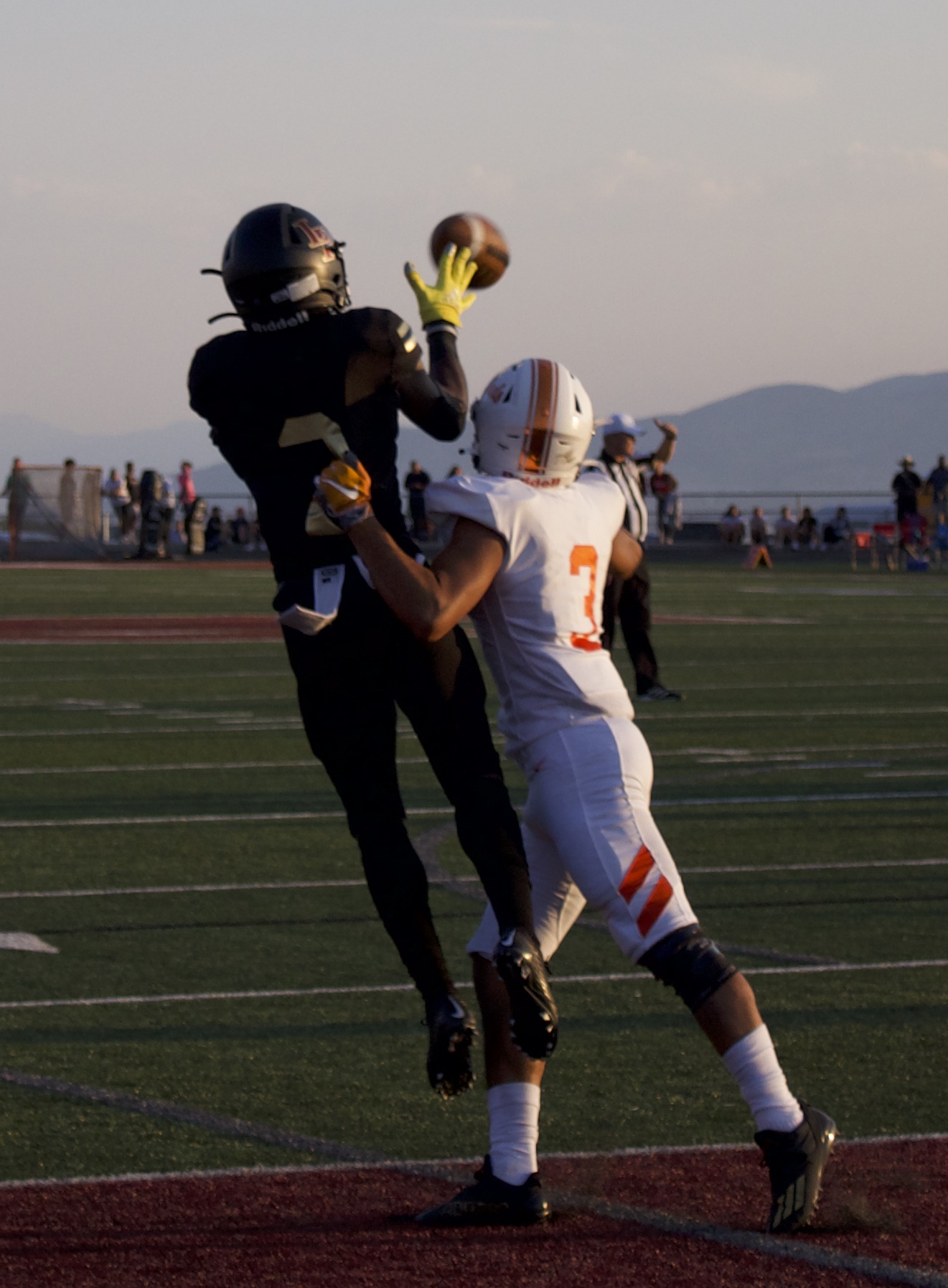Lone Peak's Luke Hyde catches a touchdown pass over Timpview's Etano Foster during the Knights' 44-31 win over Timpview, Friday, Aug. 13, 2021 in Highland.