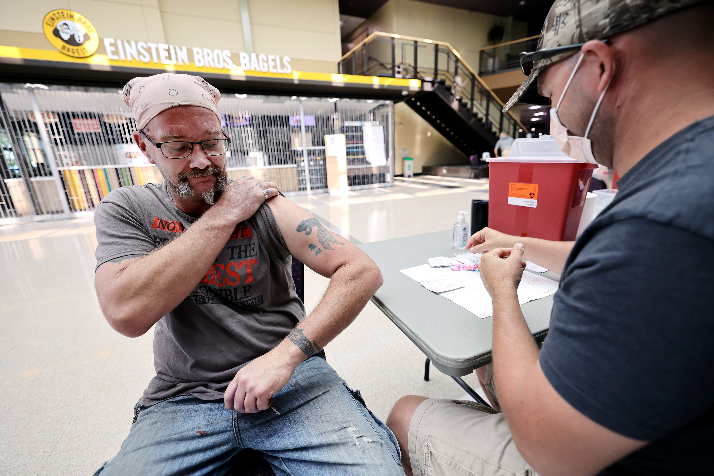 Garrett Litz pulls up his sleeve prior to receiving a COVID-19 vaccination in Ogden on Aug. 10. Utah health officials on Monday reported 2,423 new COVID-19 cases and 12 deaths from over the weekend.