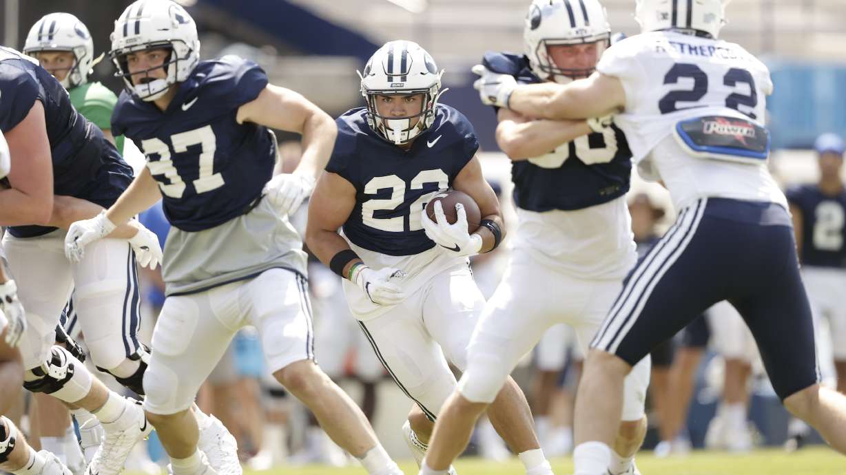 BYU running back Mason Fakahua runs between the tackles during a scrimmage Saturday, Aug. 14, 2021 at LaVell Edwards Stadium.