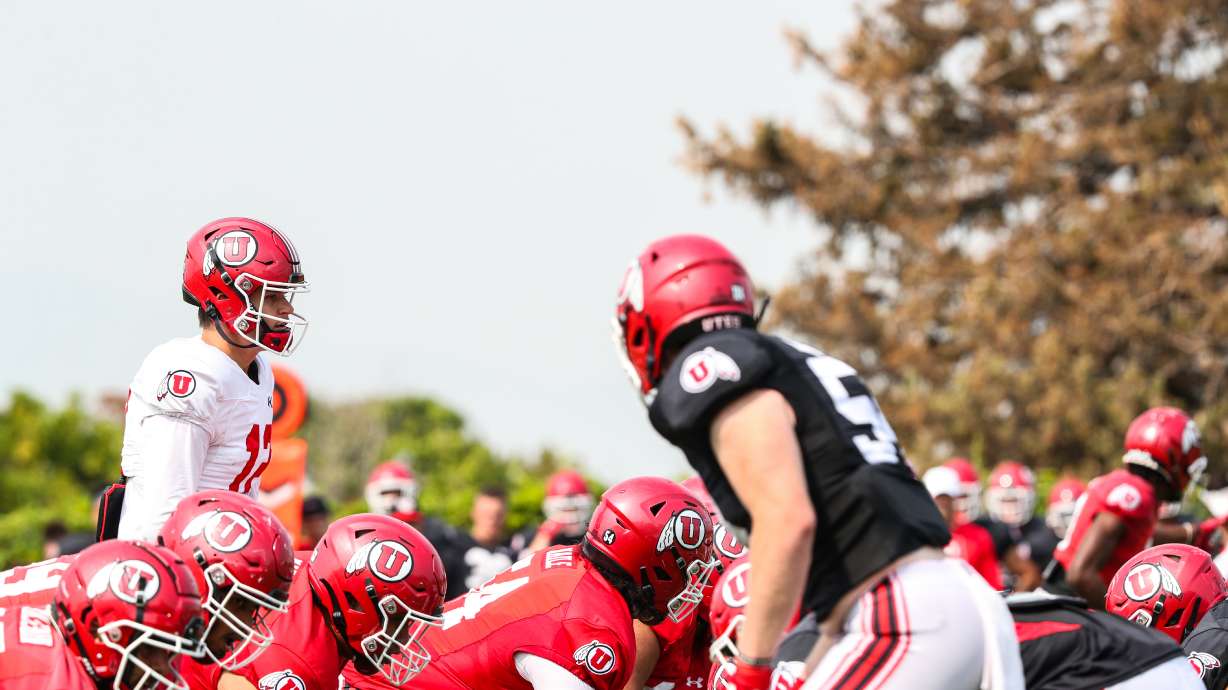 Utah senior quarterback Charlie Brewer (12) lines up under center to call a play during practice on Aug. 10, 2021.