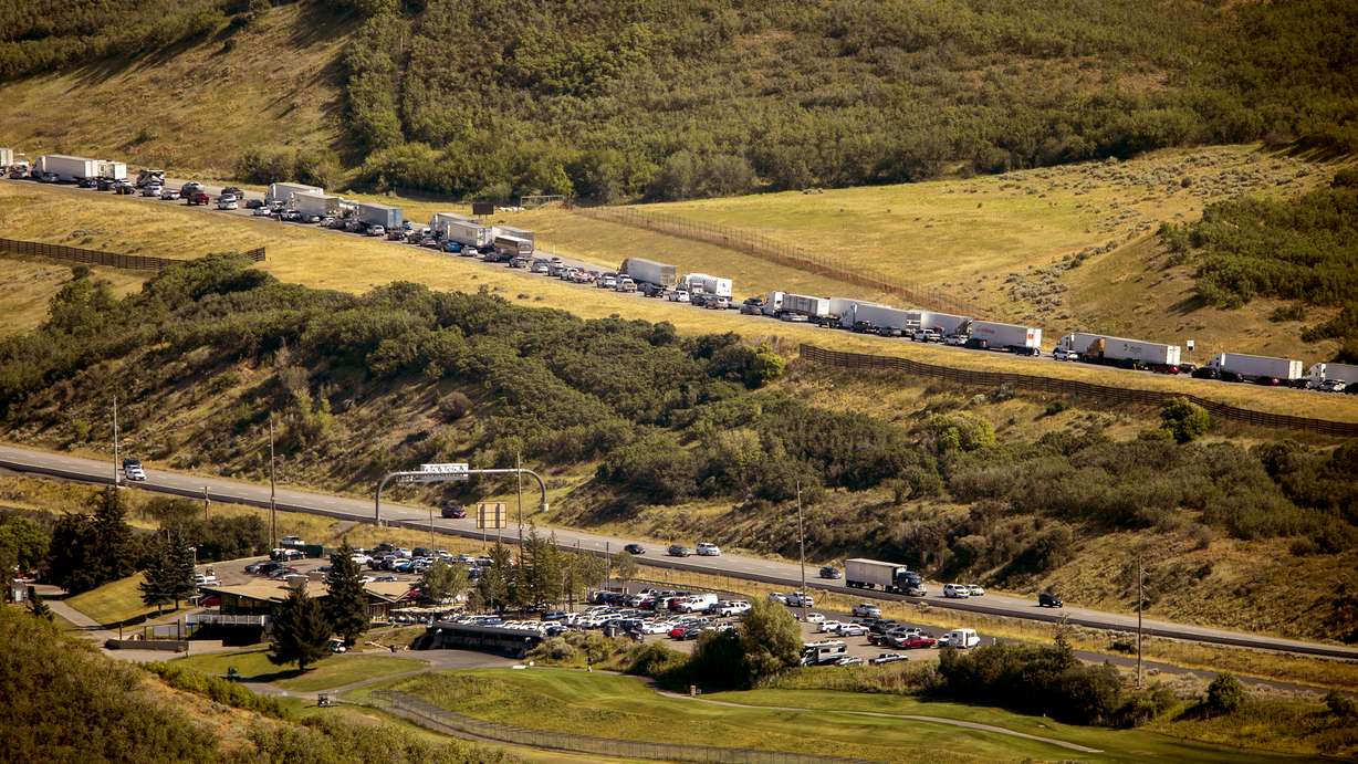 Traffic west bound on I-80 builds up as aircraft battle the Parleys Canyon west of Park City on Saturday, Aug. 14, 2021.
