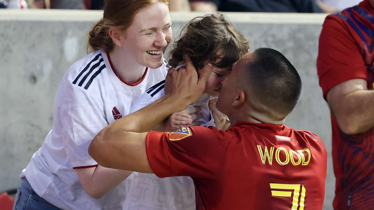 After scoring a goal, Real Salt Lake forward Bobby Wood (7) kisses his daughter Ella 2 1/2 yrs as she is held by his wife Ditte during game action with Austin FC at Rio Tinto Stadium in Sandy Utah on Saturday, Aug. 14, 2021. RSL leads 1-0 at half.