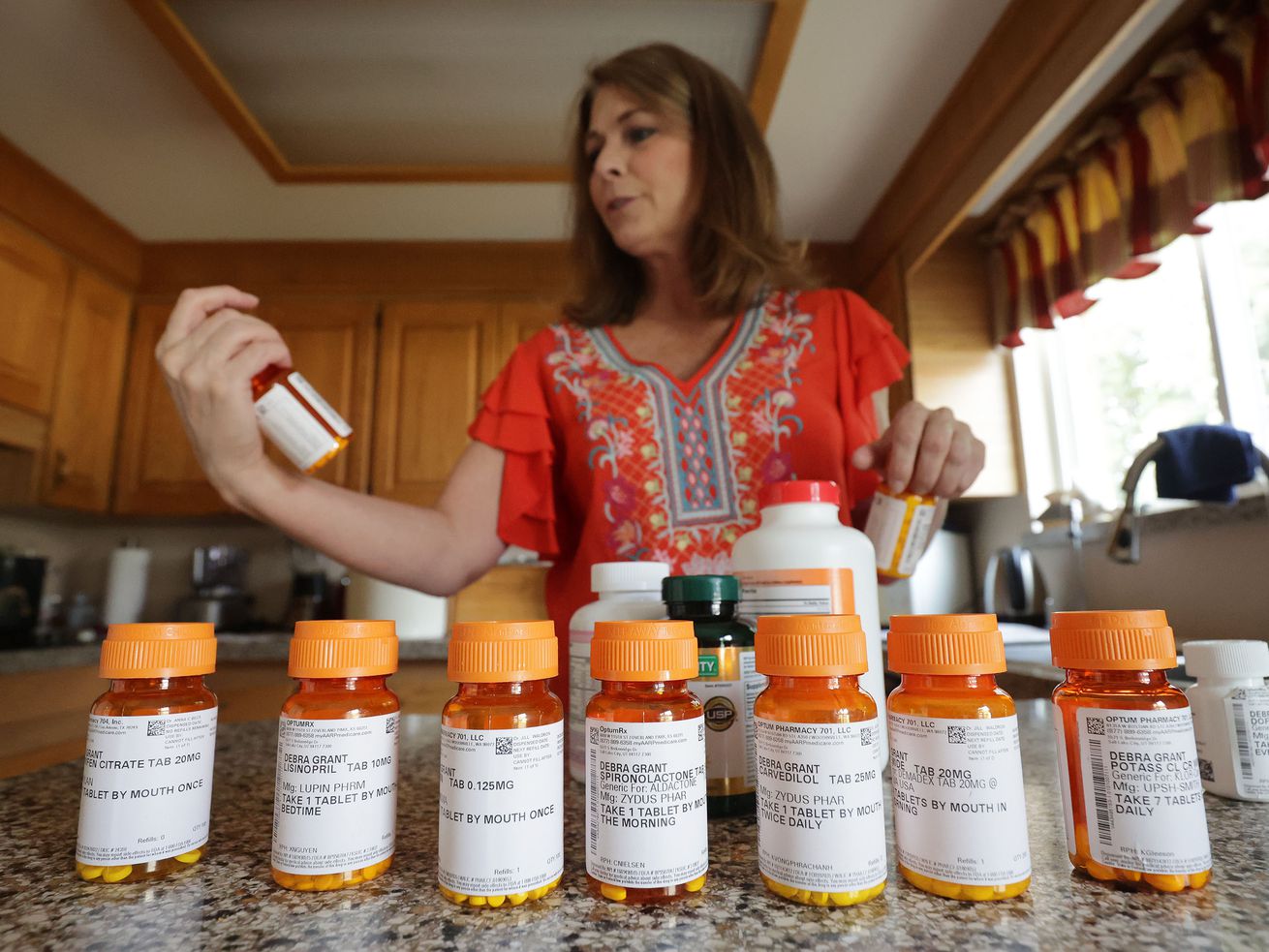 Debra Grant looks over her heart medications at her home
in Salt Lake City on Aug. 8, 2021. A protein that helps regulate calcium
signaling within heart cells could play a key role in preventing
chronic heart failure.