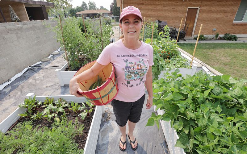Debra Grant pauses in her garden at her home in Salt
Lake City on Sunday, Aug. 8, 2021. A protein that helps regulate
calcium signaling within heart cells could play a key role in
preventing her chronic heart failure.