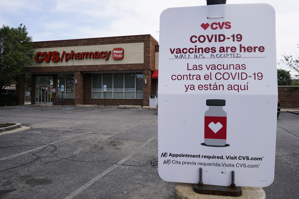 An information sign regarding COVID-19 vaccines is seen outside of a CVS store in Chicago, Illinois, on Friday. The Centers for Disease Control and Prevention gave final approval Friday to start administering Covid-19 booster shots to Pfizer and Moderna vaccine recipients hours after a key panel unanimously voted to endorse third doses for immunocompromised Americans.