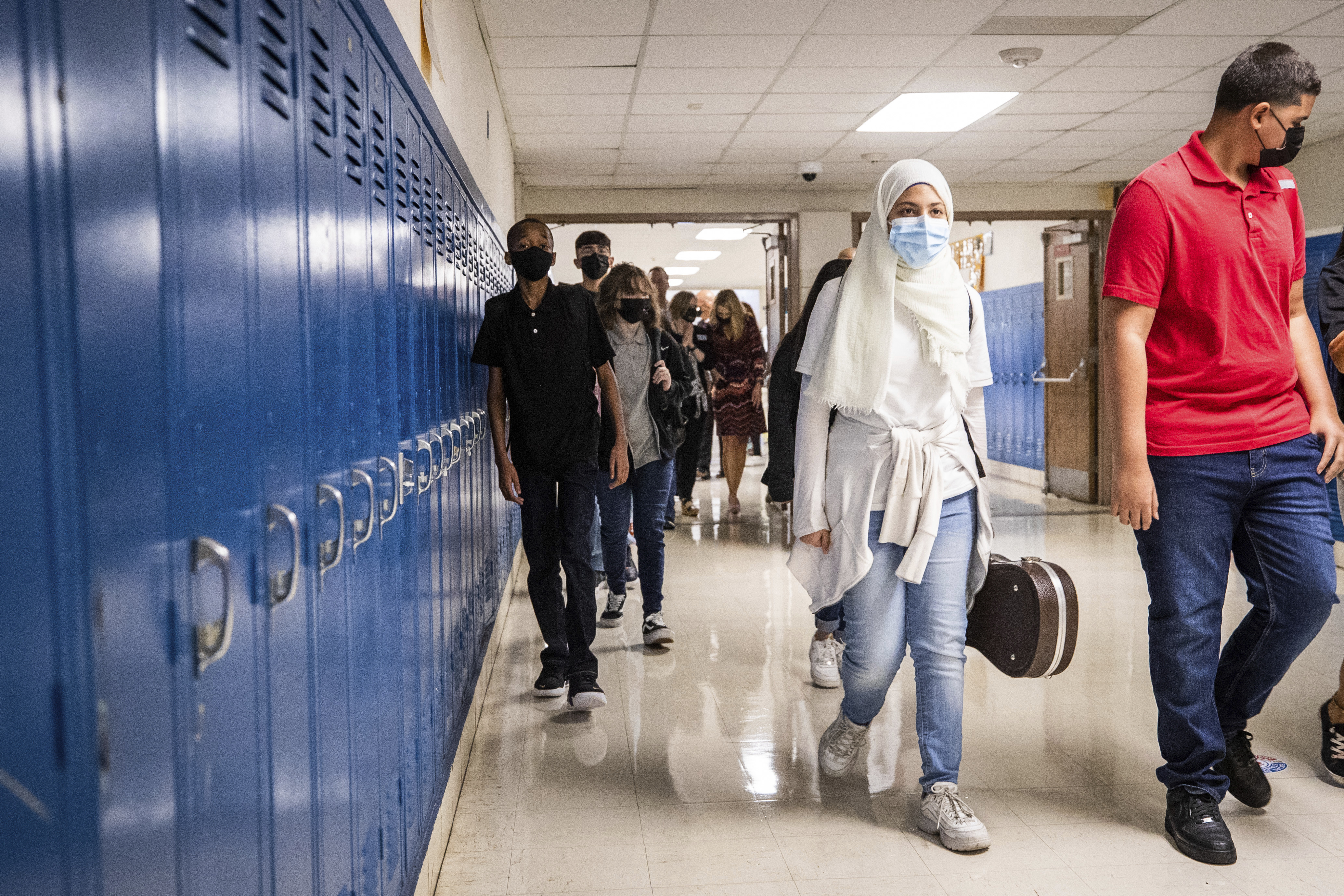 Students make their way to their classes on the first day of school Monday at Wedgwood Middle School in Fort Worth, Texas. The summer surge of the highly infectious delta variant of the coronavirus made for a disruptive start of the school year.