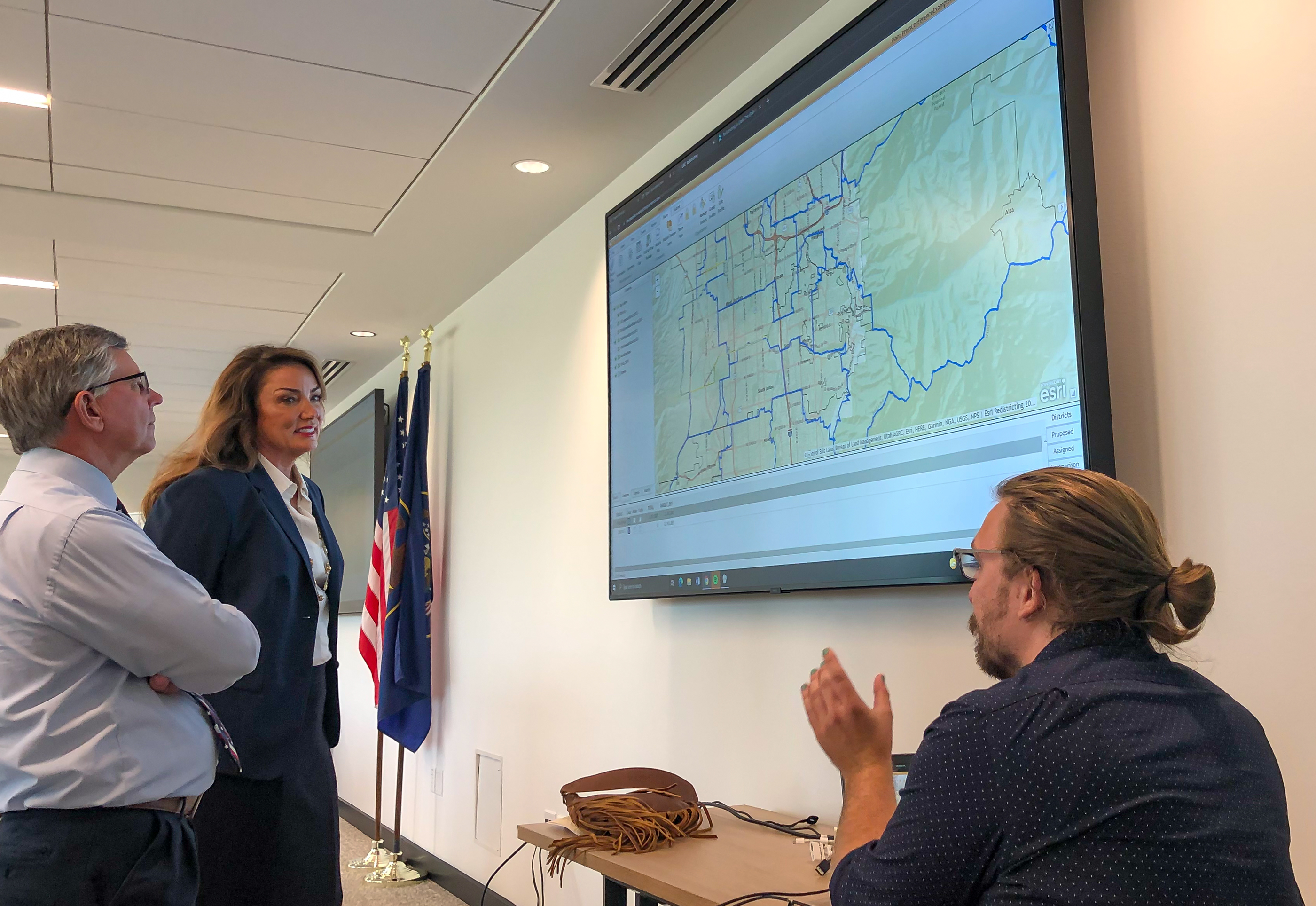 Provo Mayor Michelle Kaufusi, center, and West Jordan Mayor Dirk Burton, left, learn how an online tool used by the Utah Independent Redistricting Commission works. The tool allows users to create their own redistricting maps as a form of public comment.