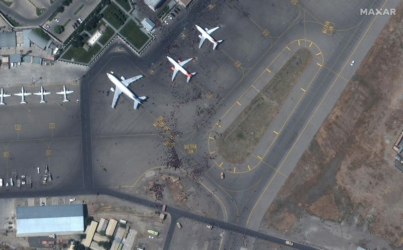 This satellite photo from Maxar Technologies shows
swarms of people on the tarmac at Kabul International Airport, also
known as Hamid Karzai International Airport, on Monday in Afghanistan. Afghans rushed onto the tarmac of the capital’s airport on Monday as thousands tried to flee the country
after the Taliban seized power with stunning speed.