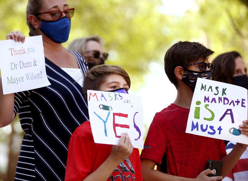 Children and parents attend a pro-mask rally at the Salt Lake County Government Center in Salt Lake City on
Aug. 12. The U.S. Department of Education announced Monday it is opening an investigation into Utah and other states that have imposed statewide bans on mask mandates in schools.