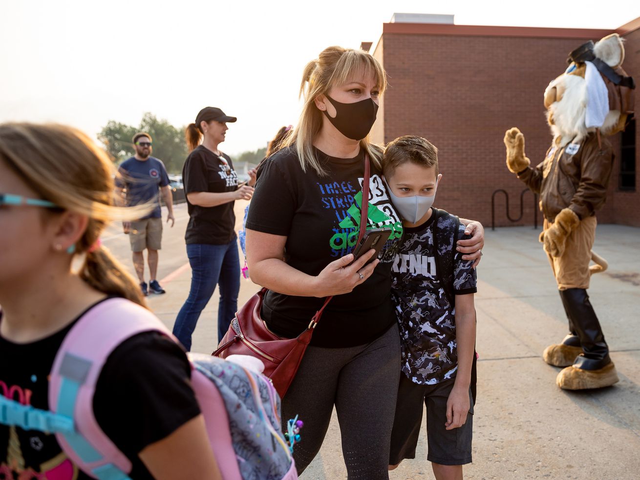 Kim Tafoya walks with her son, Dillon, 10, who is entering fifth grade, before the first day of school at Altara
Elementary in Sandy on Monday.