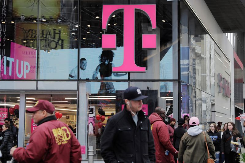 Pedestrians walk past a T-Mobile store in New York April 27, 2018. T-Mobile said Wednesday that personal data of more than 40 million former and prospective customers was stolen.