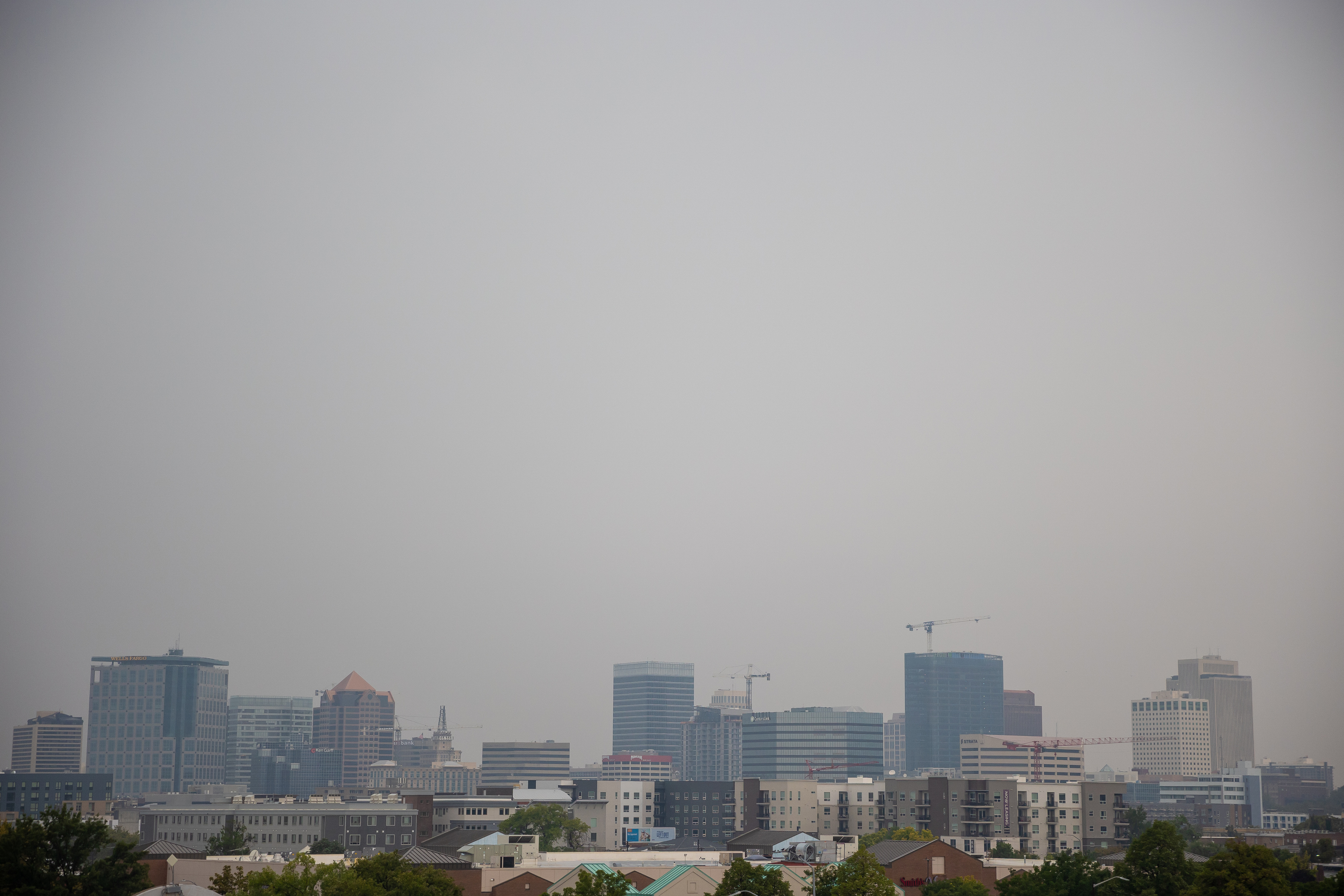Low clouds and rain, as well as poor air quality, obscure the Salt Lake City skyline on Wednesday.