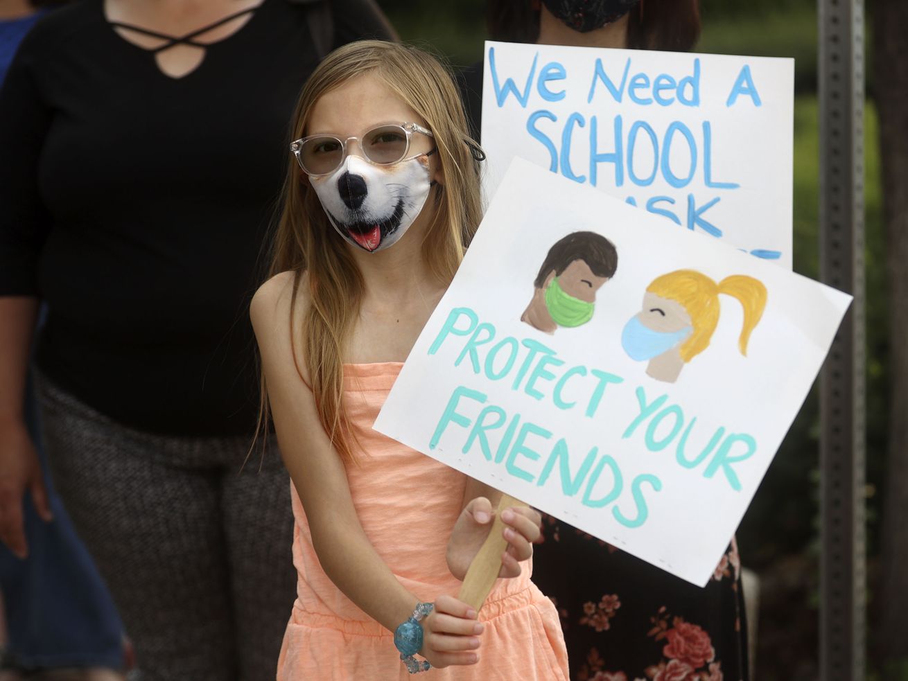 Torah Neil, 10, holds a sign in support of school mask mandates outside of the Utah State Board of Education office in Salt Lake City on Friday, Aug. 6, 2021. Elementary school students in Grand County School District will be required to wear masks indoors when school starts on Thursday under a new mask mandate.