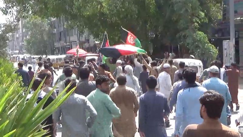 People carry Afghan flags as they take part in an anti-Taliban protest in Jalalabad, Afghanistan, Wednesday. 