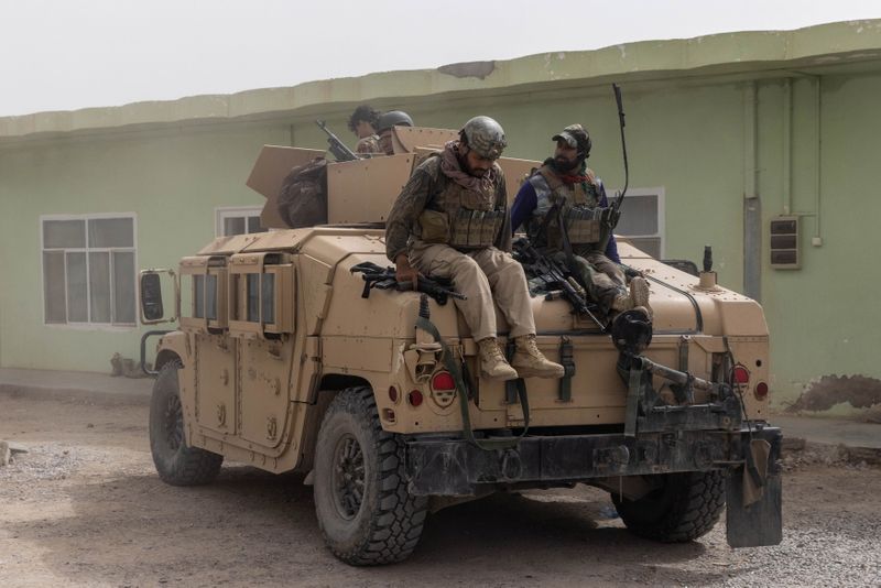 Members of Afghan Special Forces climb down from a Humvee in Kandahar province, Afghanistan on July 13. Planes, guns and night-vision goggles may be included in the Taliban's new U.S.-made war chest.