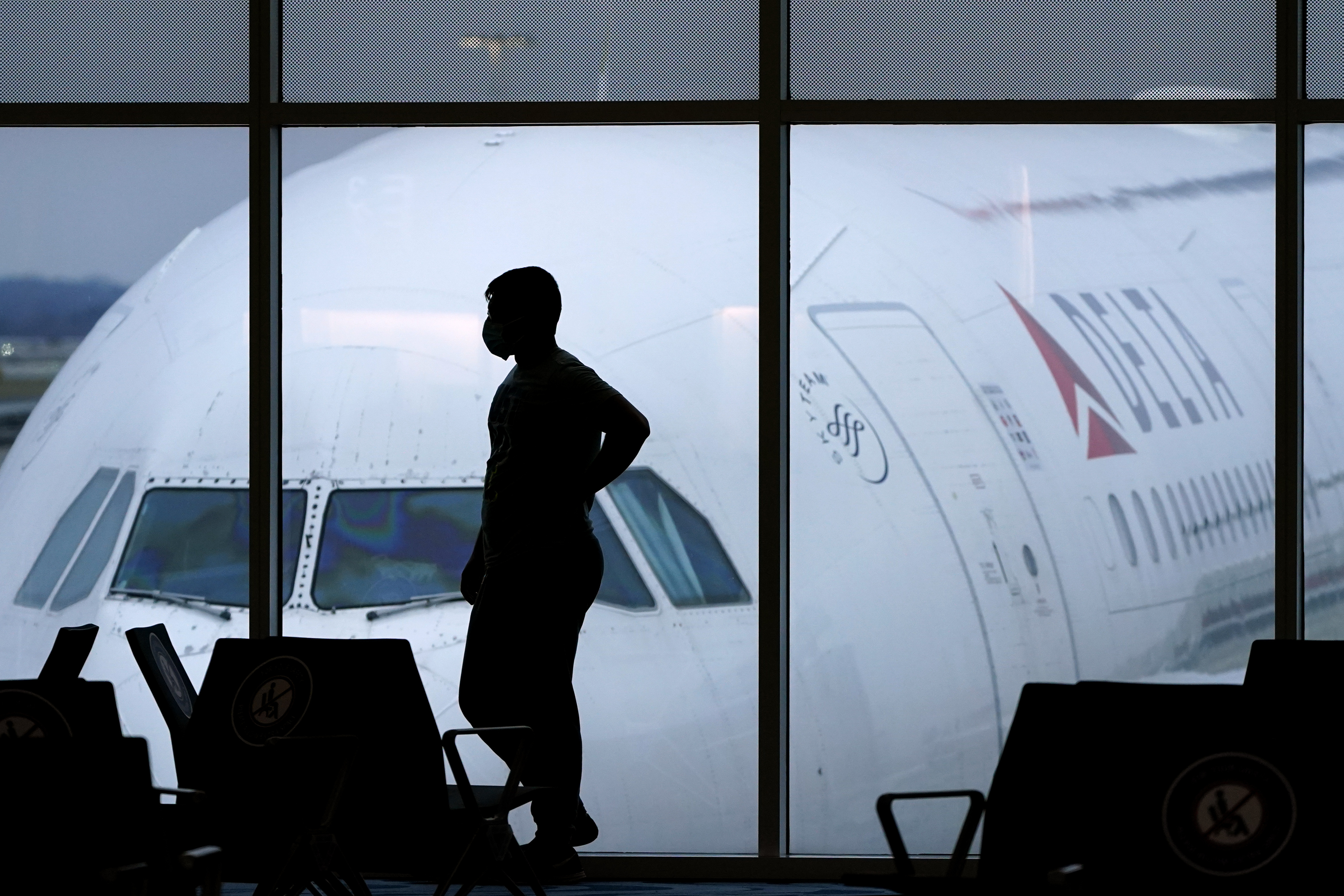 A passenger waits for a flight at Hartsfield-Jackson International Airport in Atlanta  Feb. 18. Federal officials are seeking fines against 34 more passengers accused of unruly behavior, bringing the fine total to more than $1 million this year.  