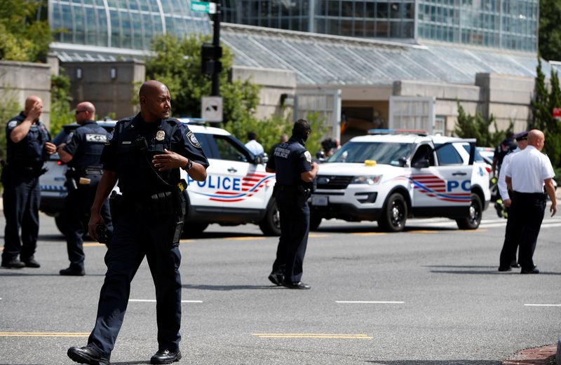 Police officers man a police barricade while responding to a bomb threat near the U.S. Capitol in Washington, Thursday.