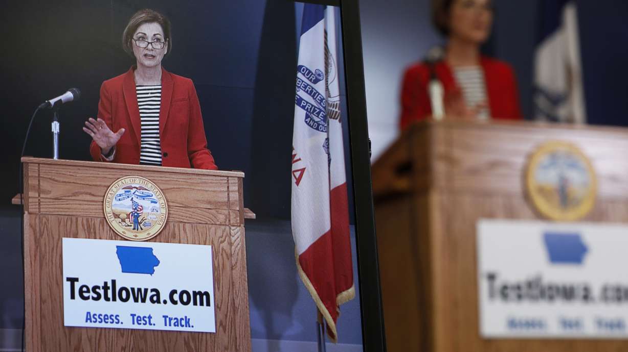 Iowa Gov. Kim Reynolds is seen on a monitor during a news conference at the State Emergency Operations Center, in Johnston, Iowa, on April 30, 2020. A new lawsuit contends that Reynolds' office is illegally delaying the release of public records related to the state's $26 million, no-bid coronavirus testing contract.