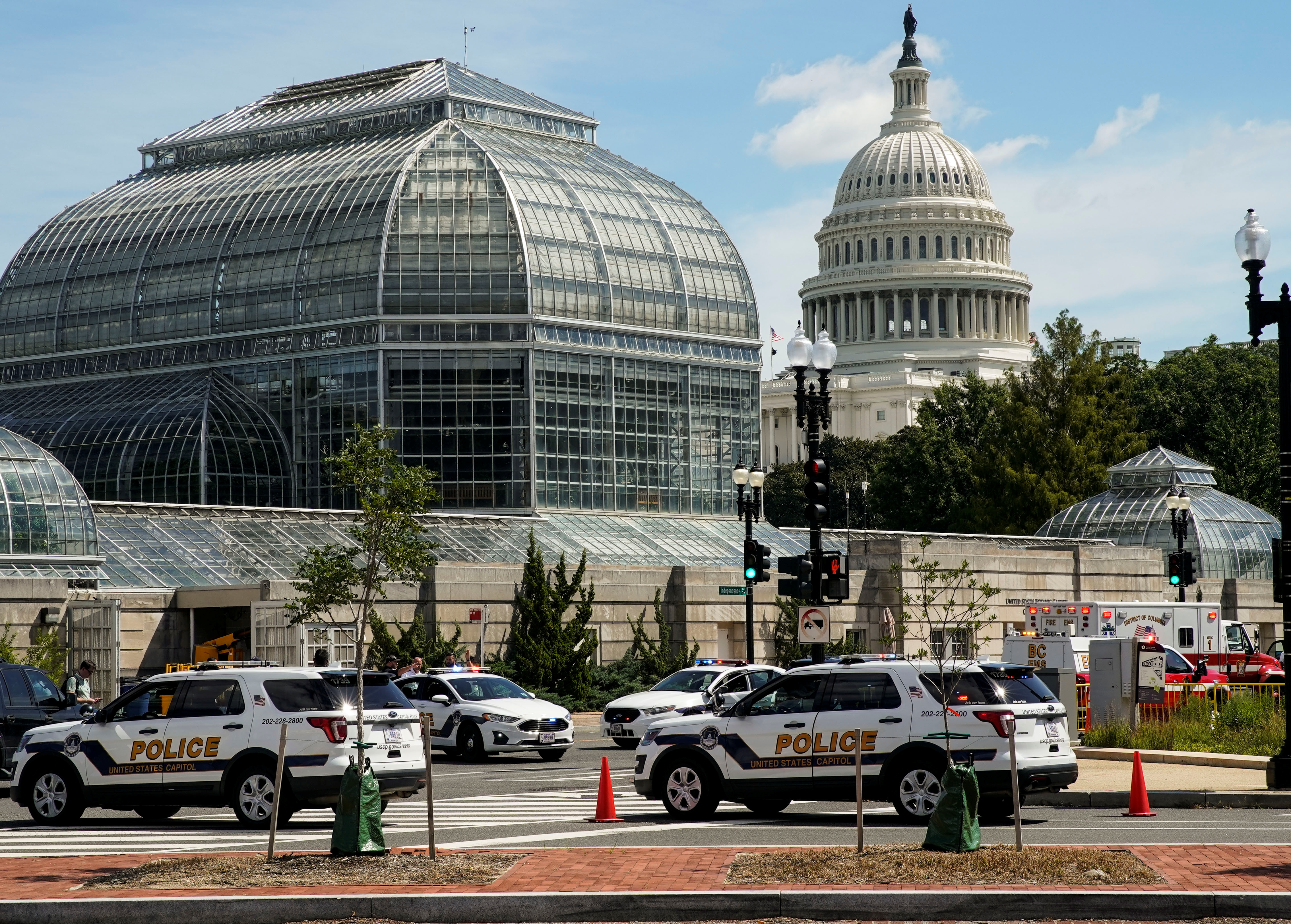 U.S. Capitol Police vehicles and other emergency vehicles respond as police investigated reports of a suspicious vehicle near the U.S. Capitol in Washington on Thursday. A man who claimed to have a bomb in a pickup truck near the U.S. Capitol was taken into custody by police on Thursday after a five-hour standoff.