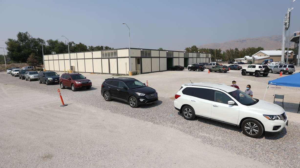 People wait in line for a COVID-19 test at the Utah State Fairpark in Salt Lake City on Monday. State health officials on Friday reported 1,116 new COVID-19 cases, including 216 in school-aged children.