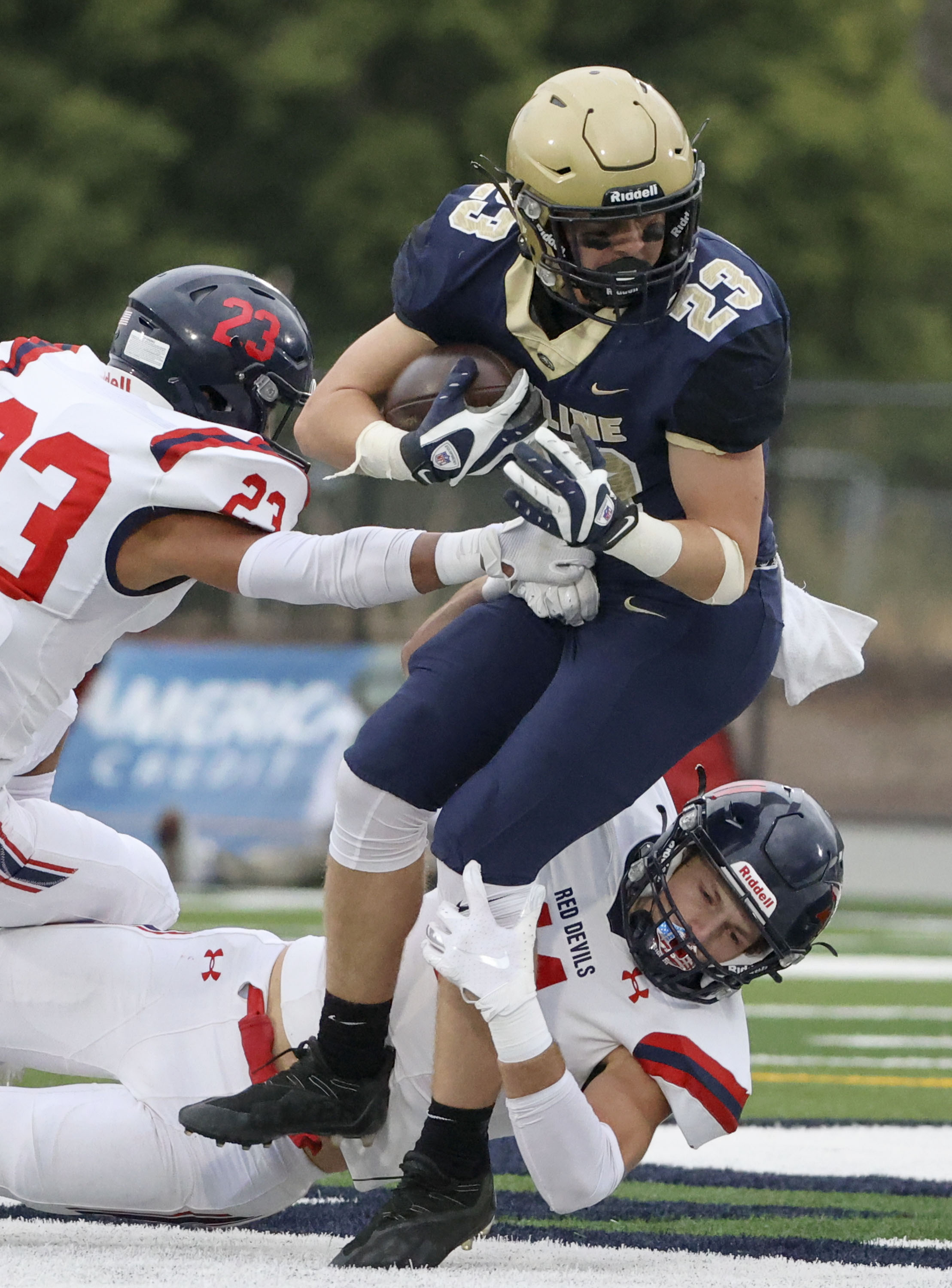 Skyline’s Bo Tate (23) is tackled by Springville’s Cole Clement (11) and Ryder Poulson (23) at Skyline High in Salt Lake City on Thursday, Aug. 19, 2021.