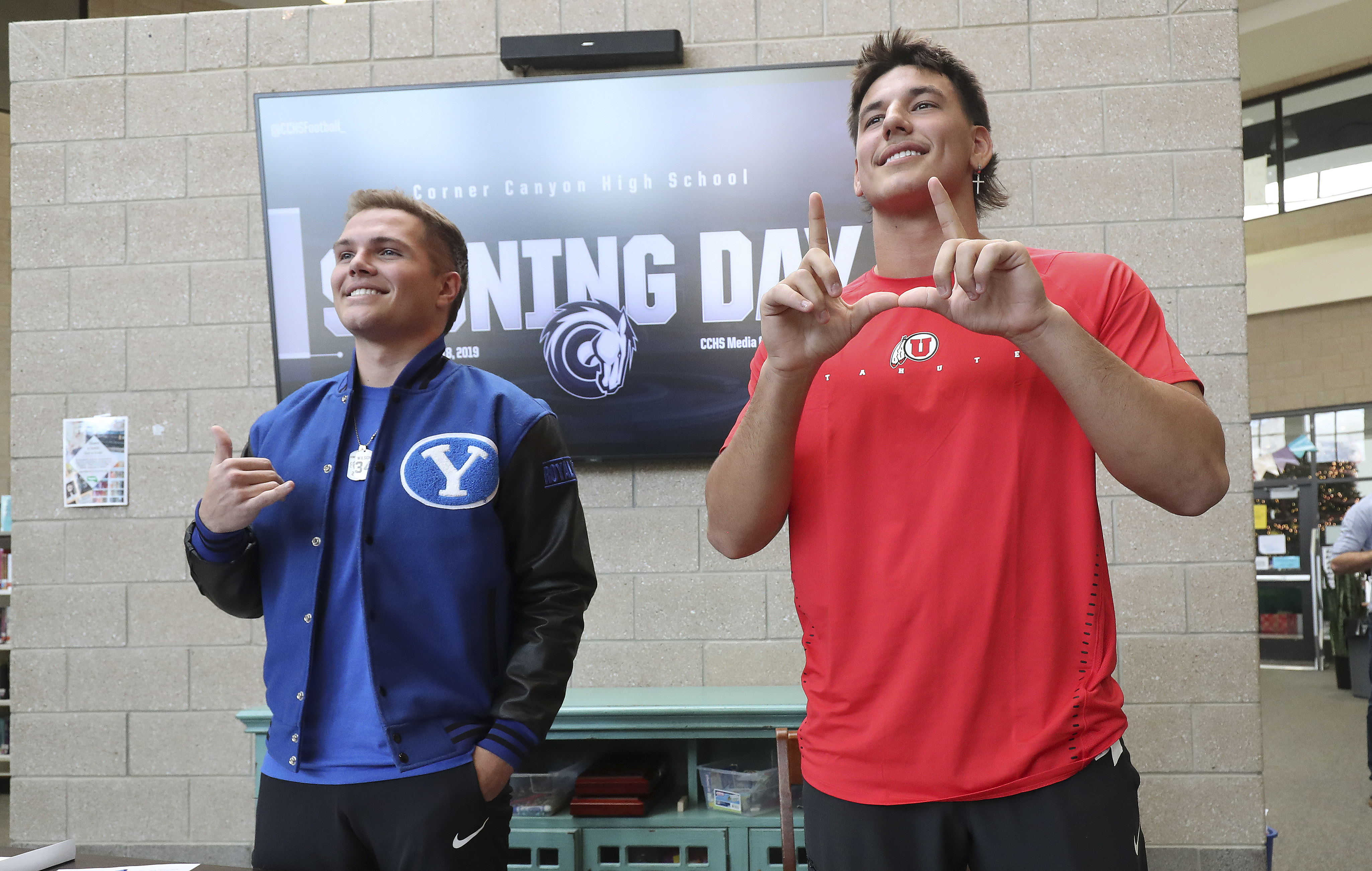 Corner Canyon High School athletes Van Fillinger, right, and Josh Wilson smile after signing their National Letters of Intent in Draper, Utah, on Wednesday, Dec. 18, 2019. Fillinger signed with University of Utah and Wilson signed with BYU.