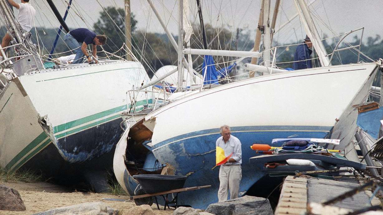 Boat owners gather their belongings in Dartmouth, Mass., after Hurricane Bob swept through, on Aug. 20, 1991. New Englanders, bracing for their first direct hit by a hurricane in 30 years, are taking precautions as Tropical Storm Henri barrels toward the southern New England coast.