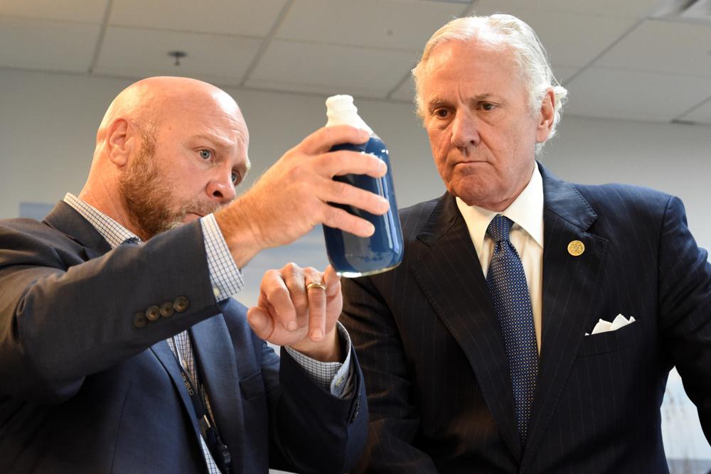 South Carolina Gov. Henry McMaster, right, listens as Foster Jordan of Charles River Labs, left, talks about the properties of horseshoe crab blood, which is a vital component in the contamination testing of injectable medicines — including the coronavirus vaccines — at Charles River Labs on Friday, Aug.6, in Charleston, South Carolina.