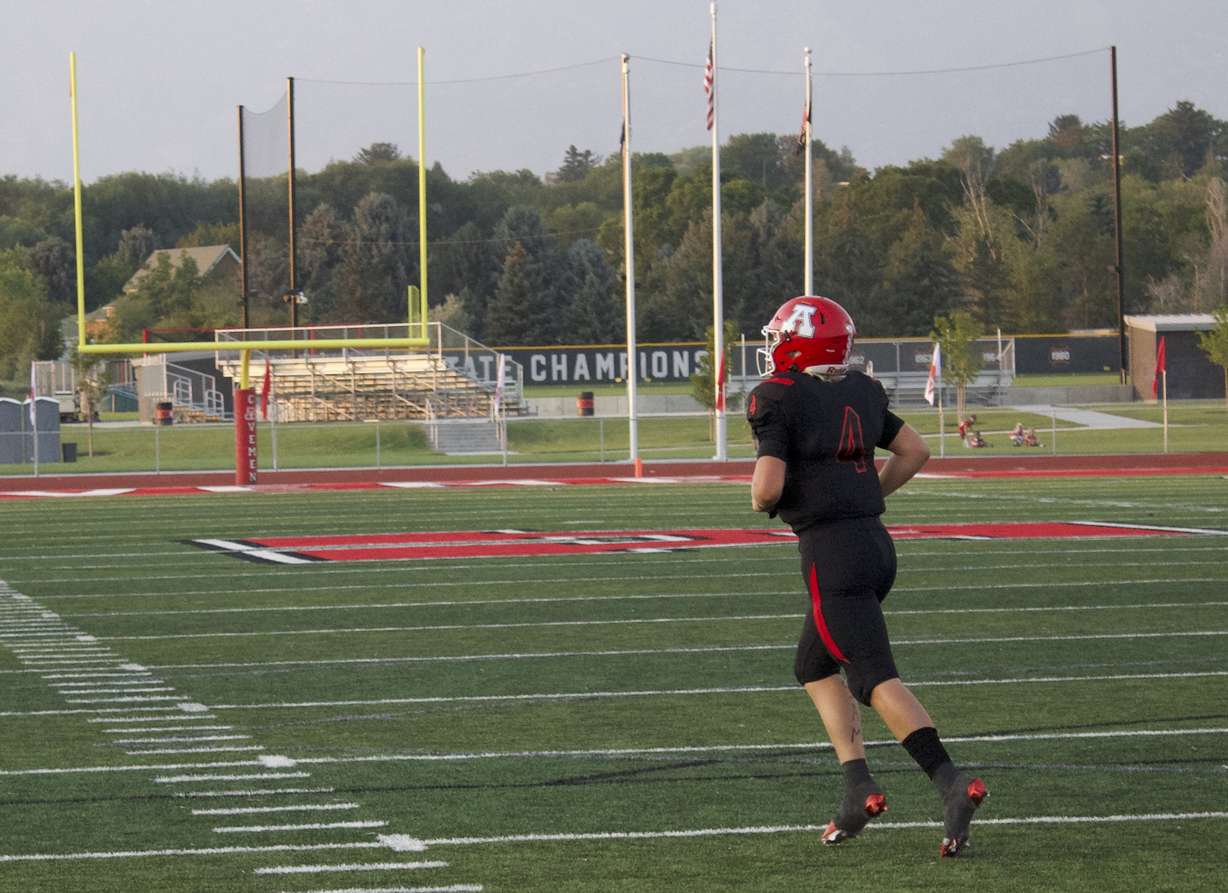American Fork quarterback Maddux Madsen jogs off the field after scoring on a QB sneak during the Cavemen's 45-14 win over Weber, Friday, Aug. 20, 2021.