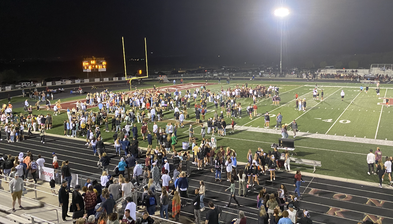 Students rush the field after Lone Peak defeats Bishop Alemany 31-24 in an upset win over the California program on Aug. 20, 2021.