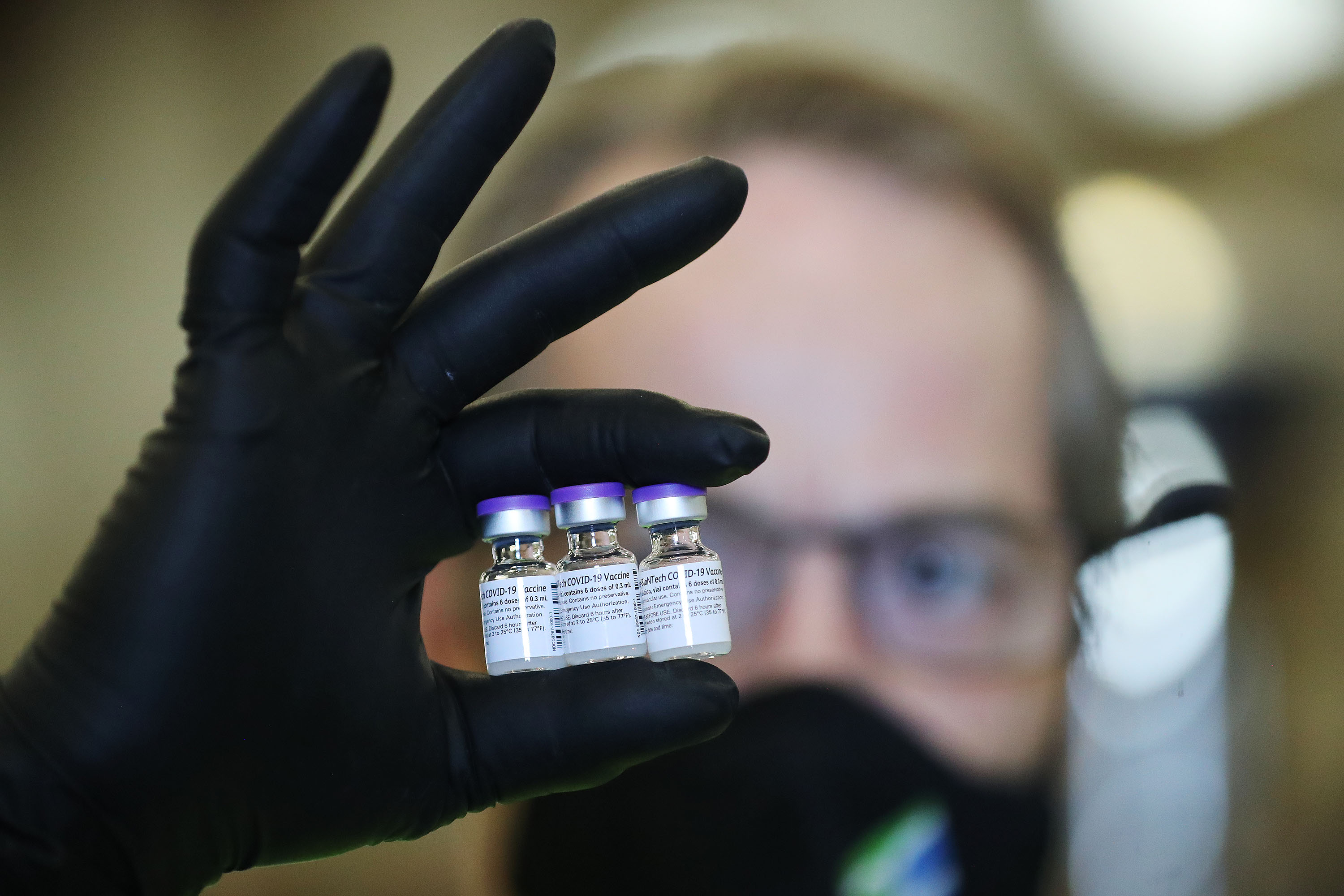 Richard Gatt holds vials of the Pfizer COVID-19 vaccine at the Legacy Events Center in Farmington on May 13. The Utah Department of Health reported 1,140 new cases Tuesday and nine deaths.