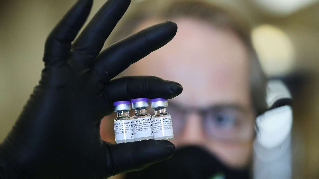 Richard Gatt holds vials of the Pfizer COVID-19 vaccine at the Legacy Events Center in Farmington on May 13. The Utah Department of Health reported 1,140 new cases Tuesday and nine deaths.