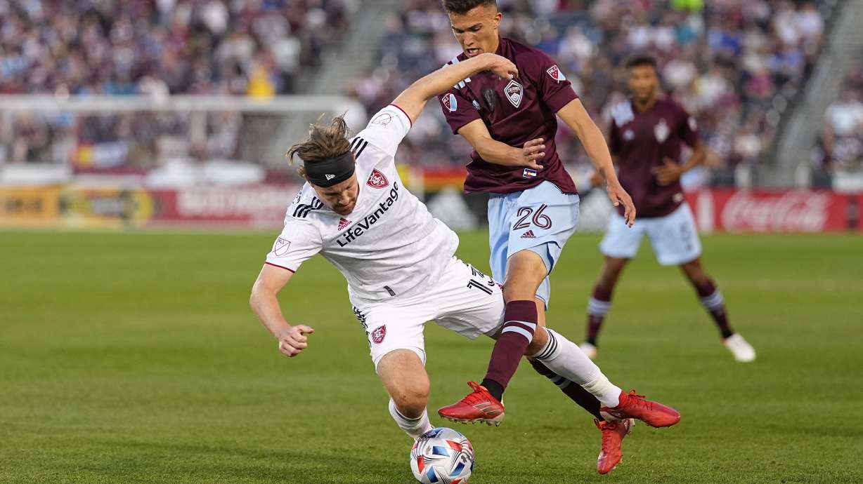 Colorado Rapids midfielder Cole Bassett (26) and Real Salt Lake midfielder Nick Besler (13) tangle during the first half of an MLS soccer match Saturday, Aug. 21, 2021, in Commerce City, Colo.