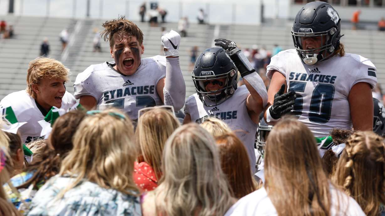 Syracuse football players cheer with the crowd after winning 31-7 against Brighton High on Saturday, Aug. 21, 2021, at Corner Canyon High School in Draper.