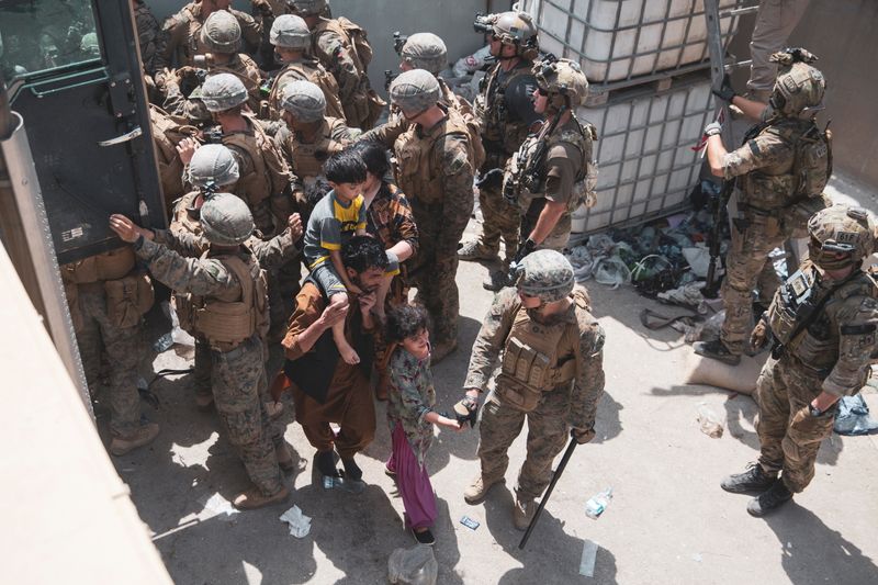 U.S. Marines and Norwegian coalition forces assist with security at an Evacuation Control Checkpoint ensuring evacuees are processed safely during an evacuation at Hamid Karzai International Airport, Kabul, Afghanistan, on Friday.