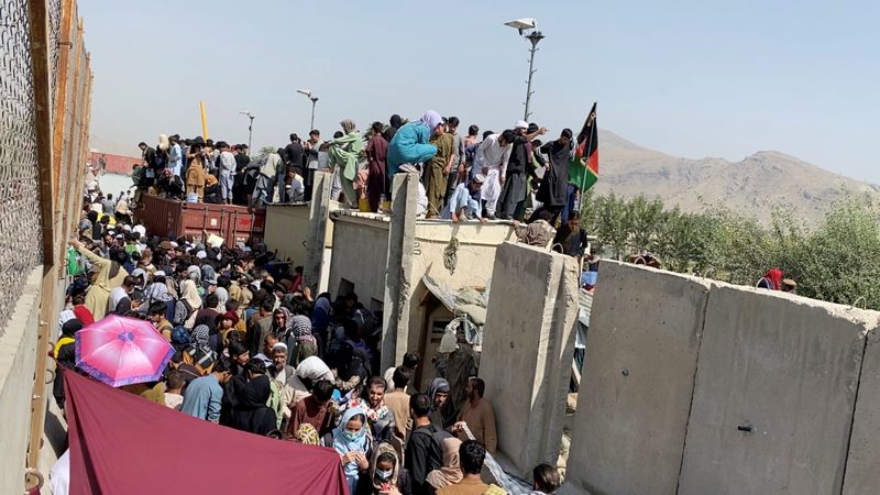 A still image taken from video shows crowds of people near the airport in Kabul, Monday.