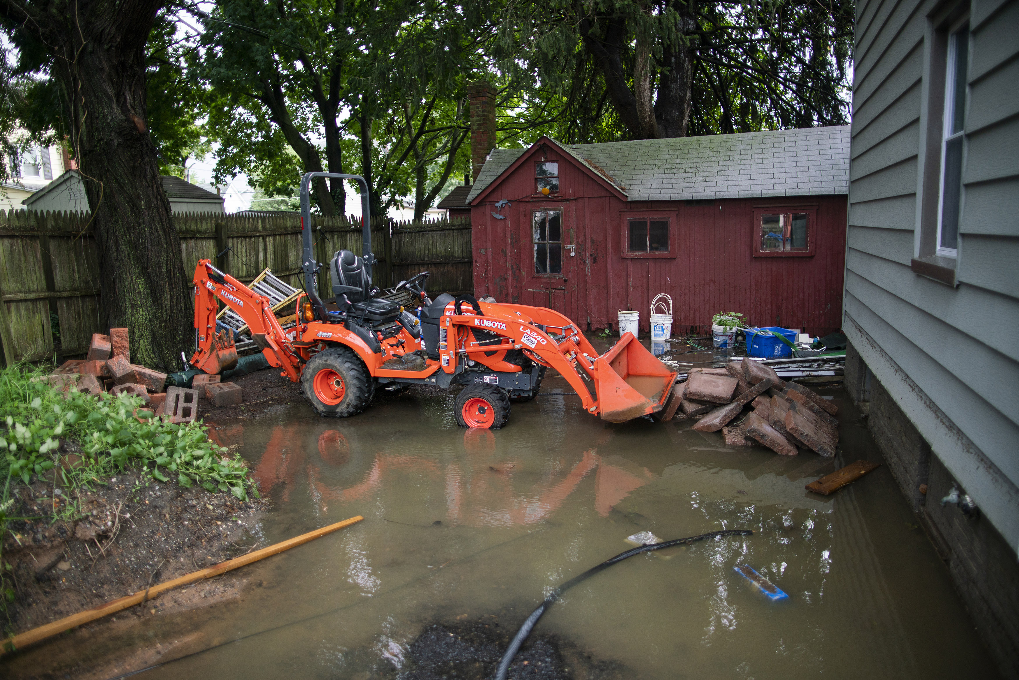 A house is seen partially flooded in Helmetta, N.J., Monday. Storm system Henri drenched much of the inland Northeast Monday.