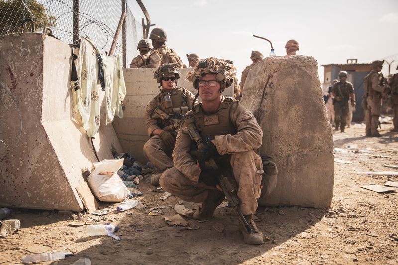 U.S. Marines take a moment to rest at an Evacuation Control Checkpoint during an evacuation at Hamid Karzai International Airport, Kabul, Afghanistan, on Aug. 20.