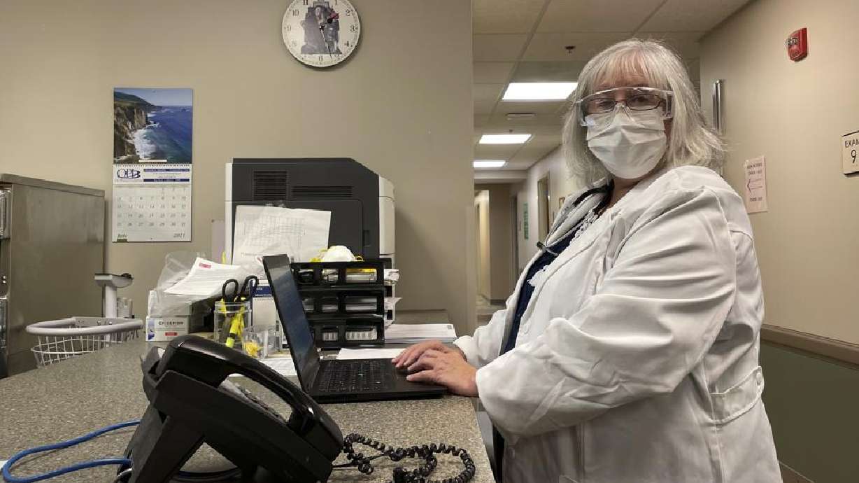 Dr. Sara Goza looks over while working at First Georgia Physician Group Pediatrics in Fayetteville, Ga., Tuesday, Aug. 17, 2021. The vaccinations that U.S. schoolchildren are required to get to hold terrible diseases like polio, hepatitis, tetanus and whooping cough in check are way behind schedule this year, threatening further complications to a school year already marred by COVID-19.