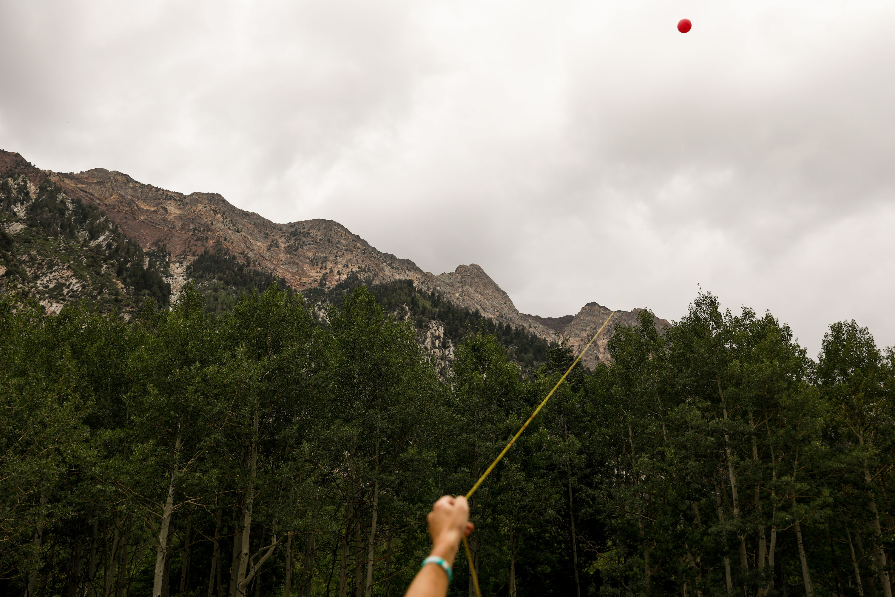 A demonstrator flies a balloon in Little Cottonwood Canyon to demonstrate how erecting poles for a gondola would impact views inside the canyon on Saturday, Aug. 21, 2021, in Sandy.
