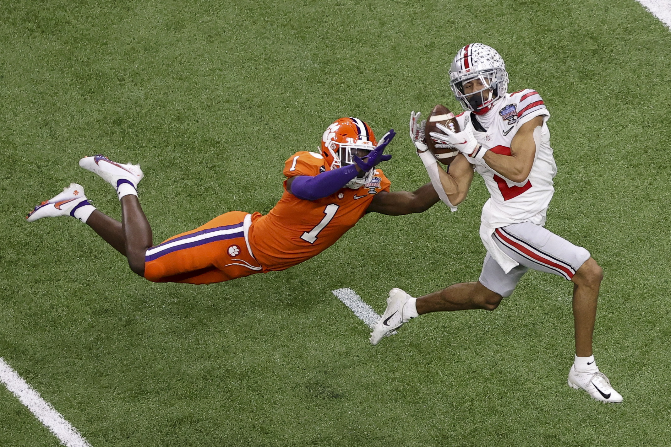 Ohio State wide receiver Chris Olave catches a touchdown pass in front of Clemson cornerback Derion Kendrick during the second half of the Sugar Bowl NCAA college football game in New Orleans, in this Jan. 1, 2021 photo.