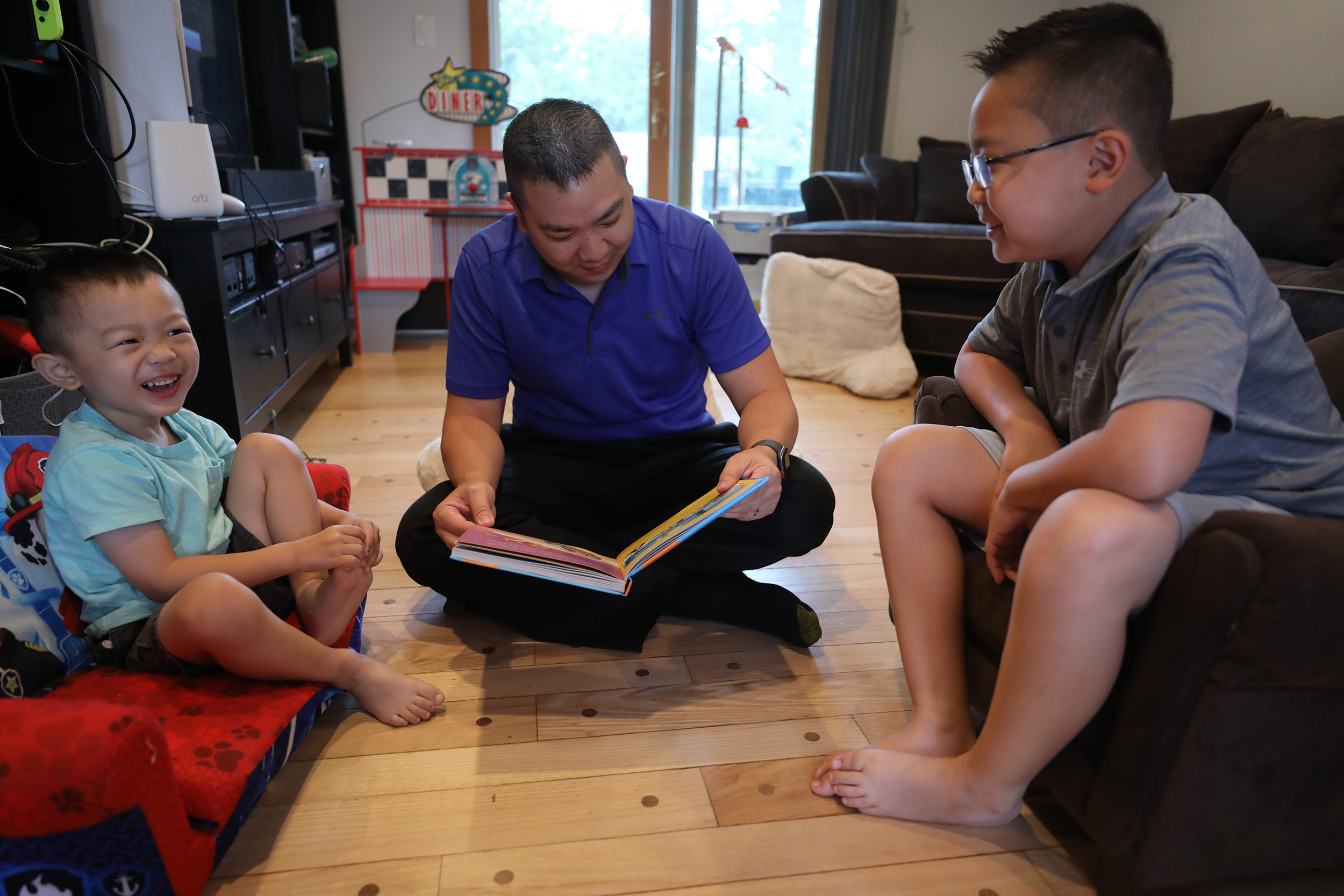 Dr. Minh-Tu Do reads a book to his sons Joey, 4, and Justin, 9, at home. Both children received the COVID-19 vaccine as part of a Pfizer-BioNTech clinical trial with Rutgers University .Parents are clamoring to hear more about approval or authorization for children under 12 now that the FDA has given full approval to Pfizer's coronavirus vaccine for people age 16 and older. 