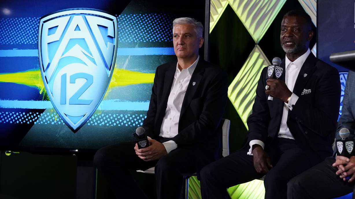 Pac-12 Commissioner George Kliavkoff, center, and Senior Associate Commissioner for Football Operations Merton Hanks field questions during the Pac-12 Conference NCAA college football Media Day Tuesday, July 27, 2021, in Los Angeles.