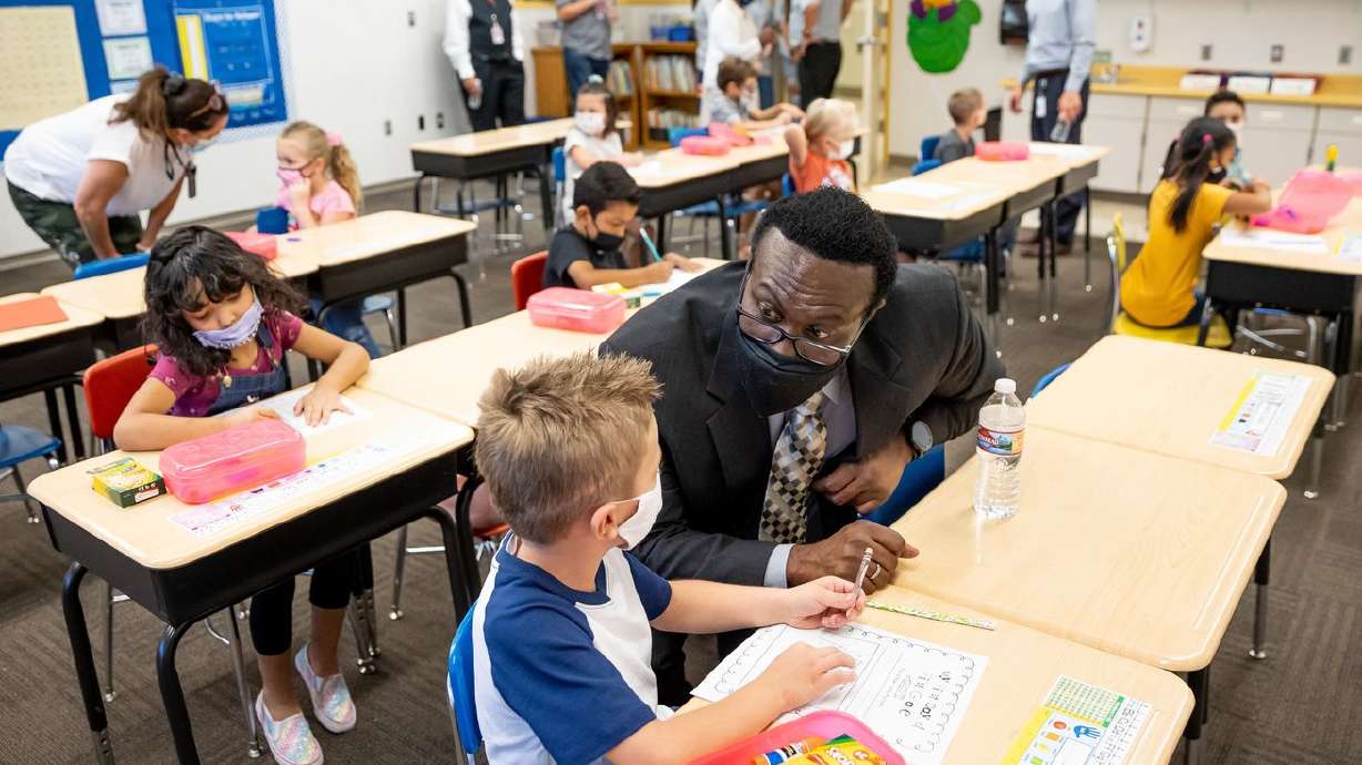 First grader Kash Zechman chats with Salt Lake City School District Superintendent Timothy Gadson III while he tours Nibley Park School in Salt Lake City on Tuesday, Aug. 24, 2021. The first day of school put to the test Salt Lake City Mayor Erin Mendenhall’s order requiring masks in K-12 schools.